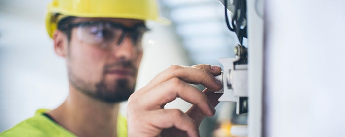 industrial worker adjusting controls