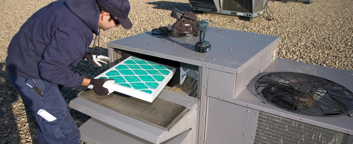 worker changing air filter